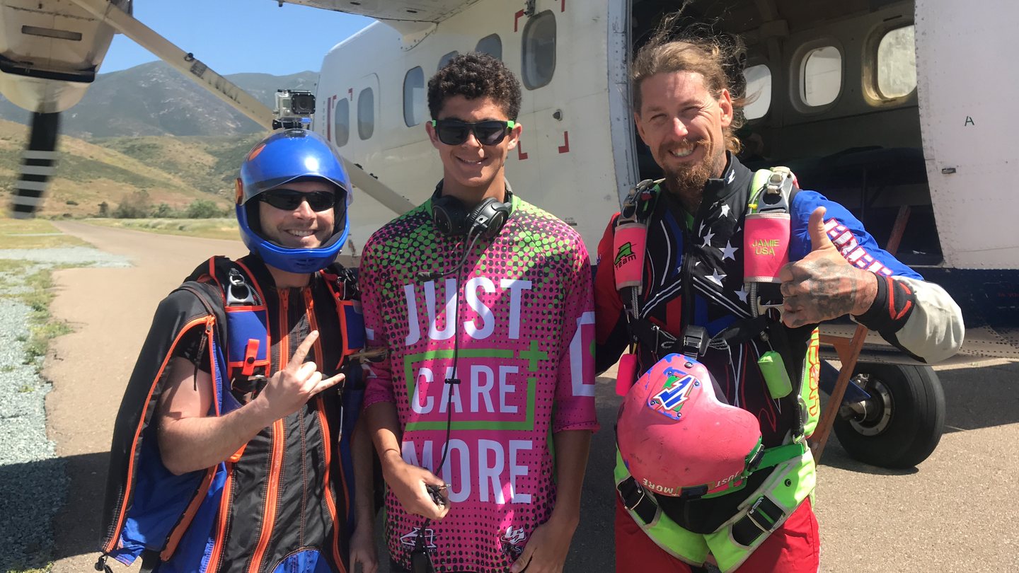 Camp Care More -- youth adventure program by Just Care More, at-risk youth with skydiving gear and Just Care More gear